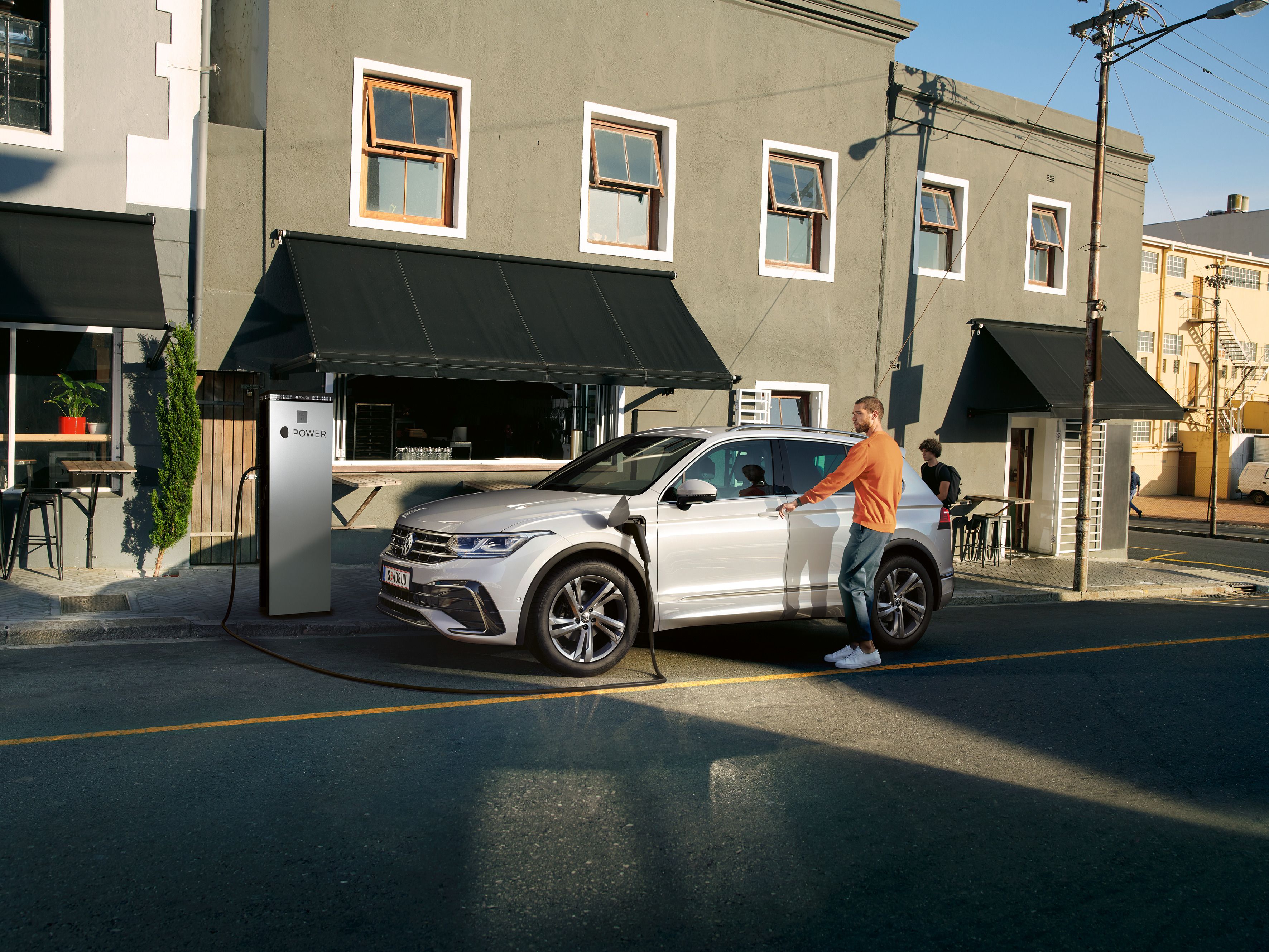 VW Tiguan hängt an Ladestation vor Haus