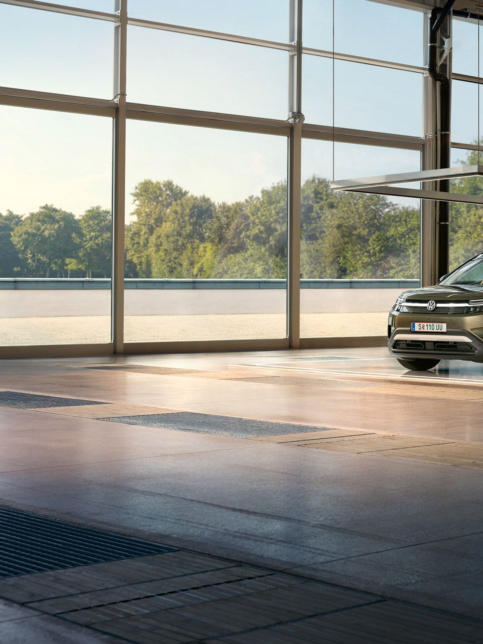 VW ID. Cross е паркиран в минималистично дизайнерско студио, до него развълнуван мъж подскача и разговаря с инженер.
