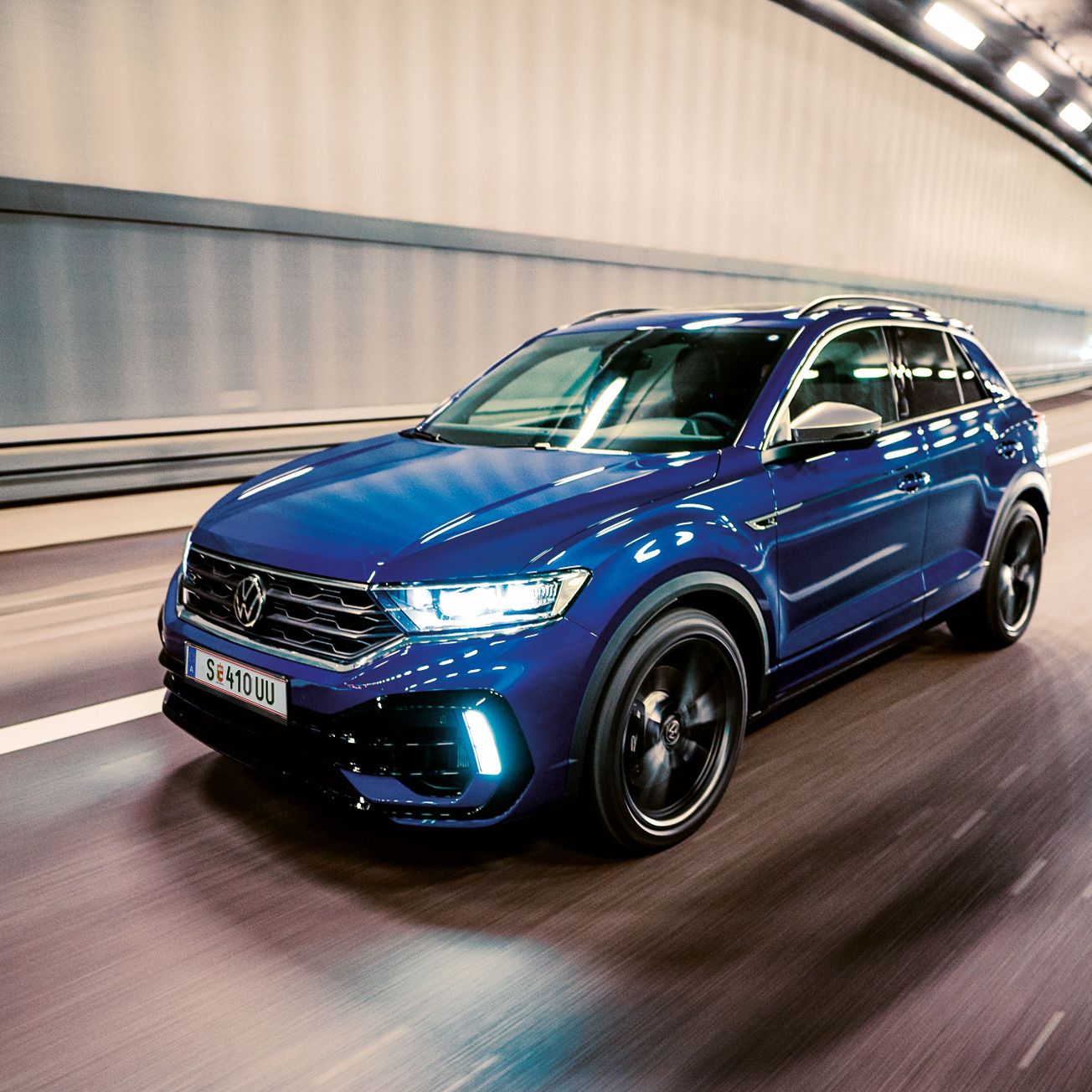 Син Volkswagen T-Roc R в динамично движение през осветен градски тунел
