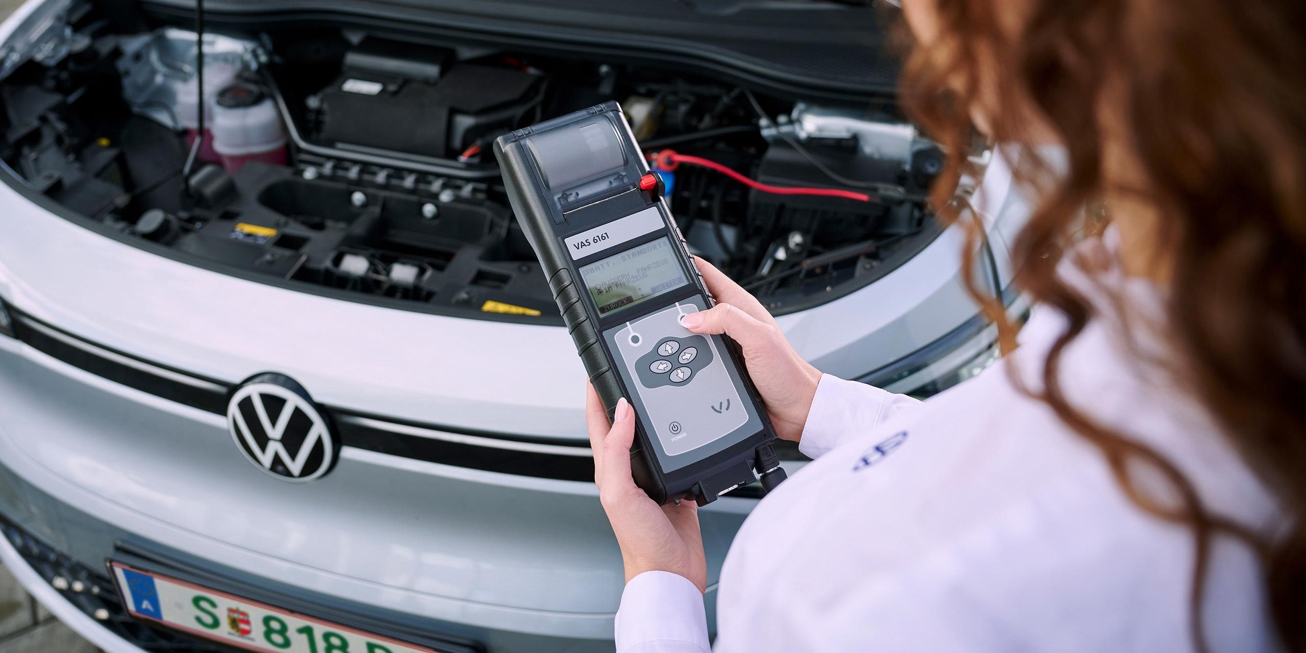 Eine VW Technikerin beim Elektroautoservice für einen Volkswagen ID